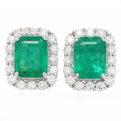 Pair of 18ct white gold emerald and diamond cluster earrings, each stud set with a single ...