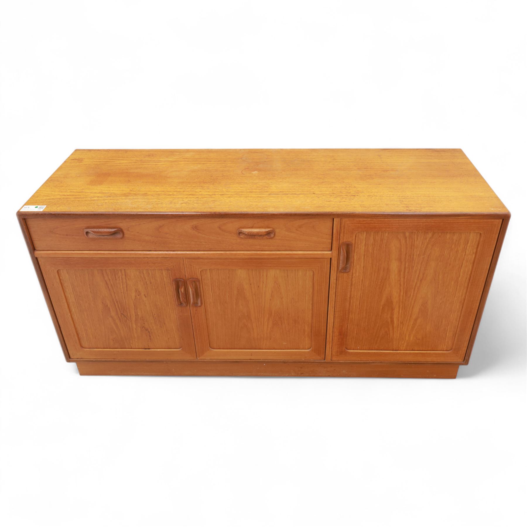 G Plan - Mid-20th century teak sideboard, fitted with single drawer above three cupboard doors, recessed handles throughout, raised on a plinth base