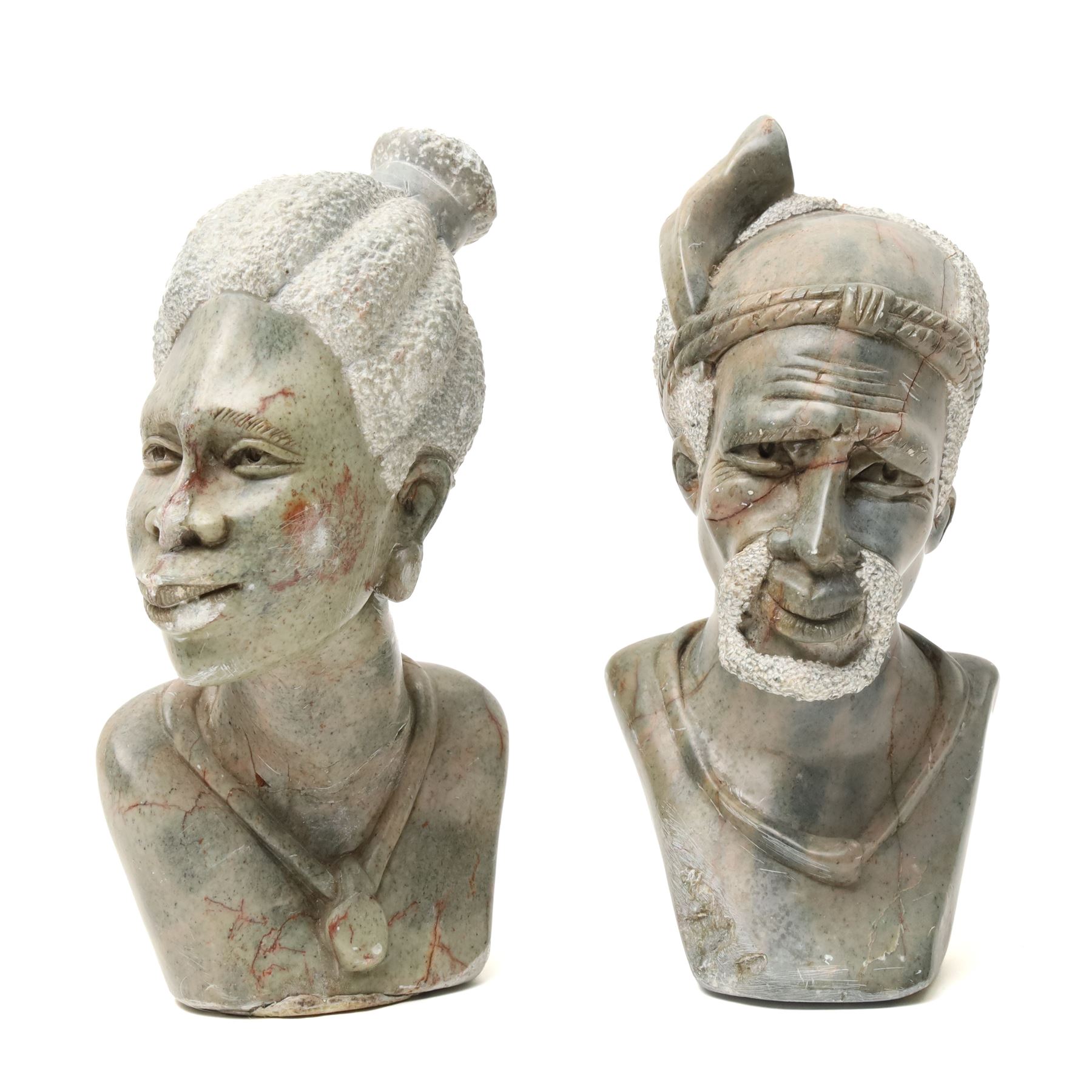 Carved African stone sculptural bust, attributed to Vanassa Rangisse, faint marks to base, H31cm; together with two further stone busts, H24cm (3)