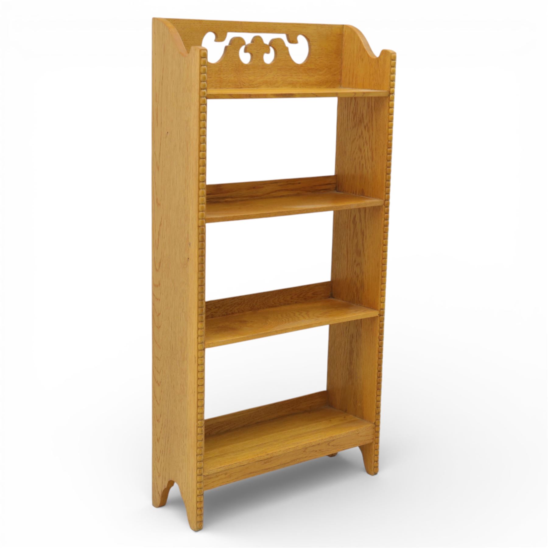 20th century small oak open bookcase, with pierced shaped cresting above four open shelves, beaded upright sides, shaped side panels, raised on shaped feet