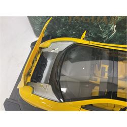 Two Maisto 1:12 scale Jaguar XJ220 ‘Racing’ cars in yellow, both on plinths in original boxes 