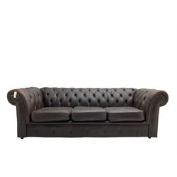 Mid-20th century three seat Chesterfield sofa, upholstered in buttoned chocolate brown leather with studwork border, on castors