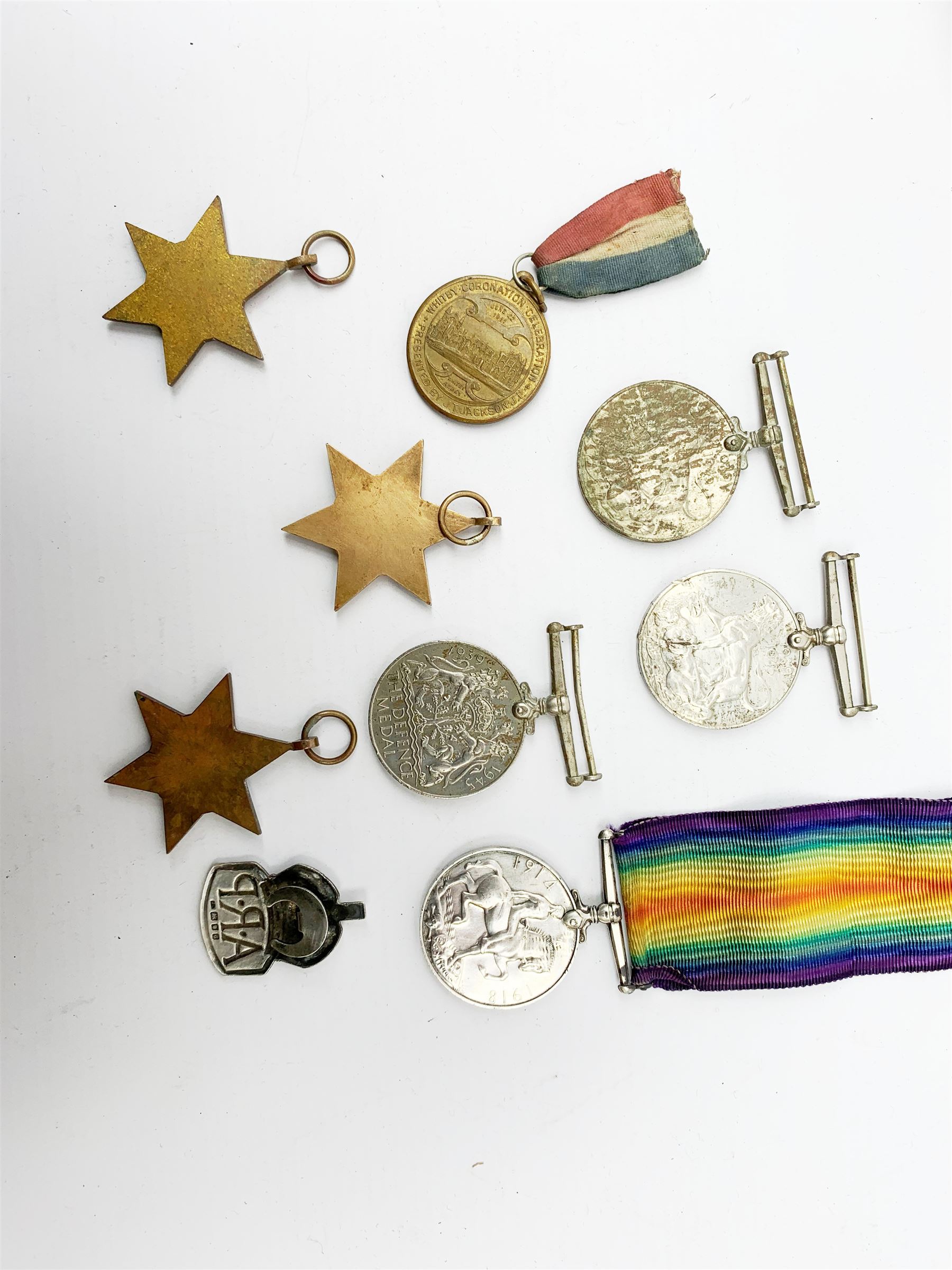 WWI British War medal awarded to 1261 Dvr. T. Paylor R.A., six WWII medals including three stars, WWII souvenir matchbox sleeve, hallmarked silver ARP badge, and an album of photographs and postcards of WWII interest, including Hitler, Montgomery, Churchill, action shots, aircraft, etc. 