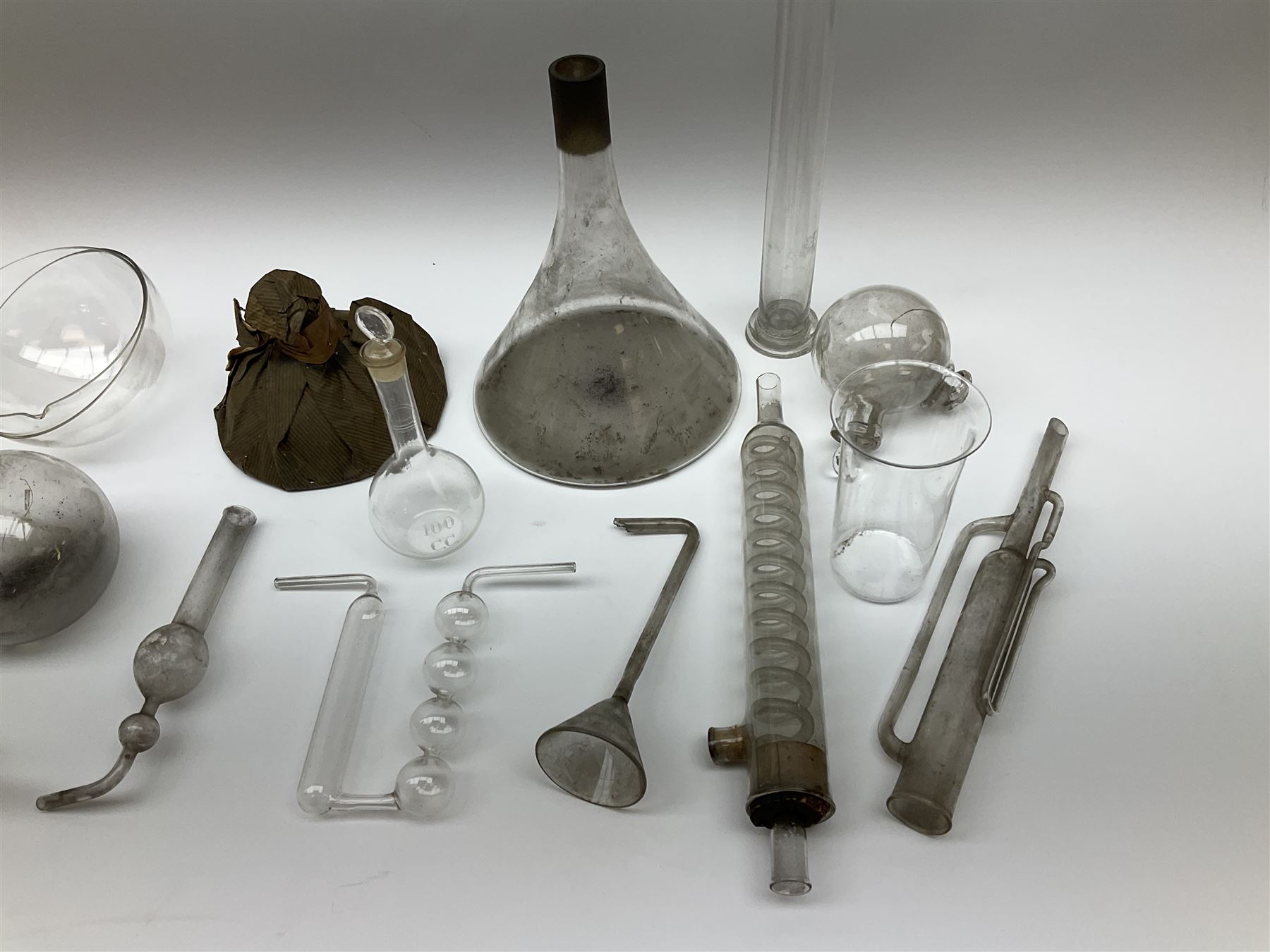 Collection of 19th century and later pharmaceutical laboratory glass, to include, volumetric flasks of various sizes, conical flask, stratus flask, etc (25) Provenance: discovered in the storeroom of a long established Hull pharmacist and opticians