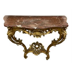 19th century giltwood and gesso console table, shaped variegated rouge marble top with moulded edge, central shell motif with extending scrolled foliage, on foliate and flower head moulded cabriole supports united by pierced shell middle rail, scrolled acanthus leaf terminals 