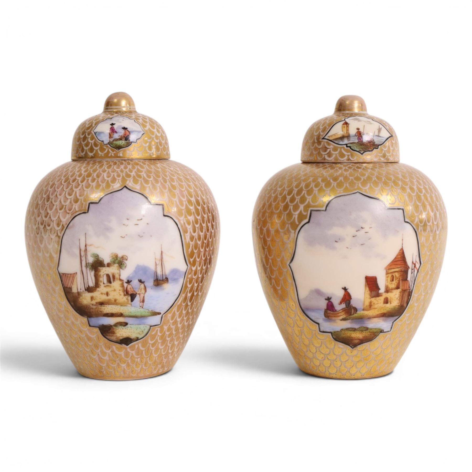 Pair of 19th century Dresden urn and covers, the central panels decorated with figures in landscapes, surrounded by gilt decoration, H15cm 