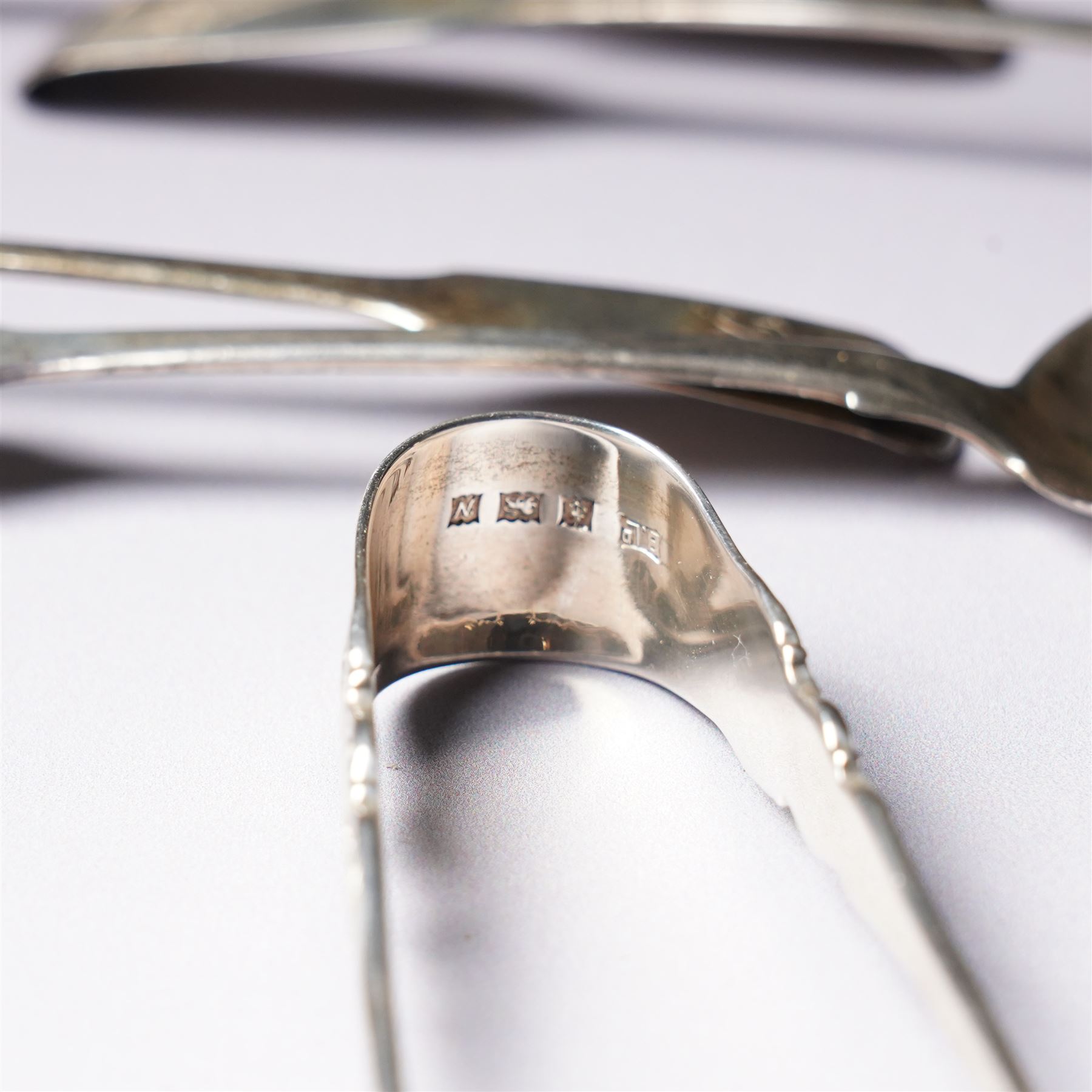 Set of six George IV silver fiddle pattern tea spoons London 1827 engraved with initials and a pair of later sugar tongs