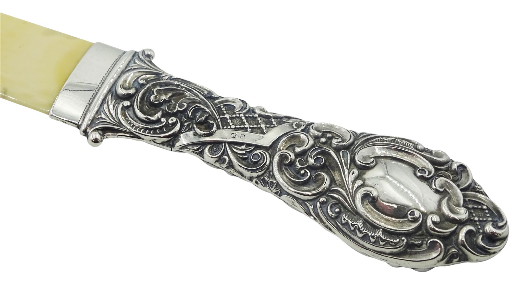 Victorian silver and ivory page turner, the repousse silver handle with foliate and C scroll decoration, hallmarked Crisford & Norris Ltd, Birmingham 1898, L35.5cm