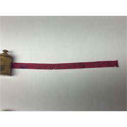 Six sewing related Mauchline ware comprising an oval reel box with internal label for Clark & Co's, tape measure, pin case and three thimble holders of ovoid form 