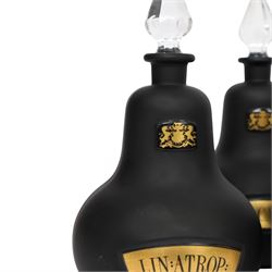 Set of four 20th century Royal Pharmaceutical Society black frosted glass bottles, of bellied form with clear cut glass spire stopper, each body bearing gilt label in Latin: LIN:AMMON:, LIN:ATROP:, LIN:CAMPH:, and LIN:CALCi:, and gilt Royal Pharmaceutical Society crest to neck, H25cm

Provenance: From the collection of the family of Peter Green, a practising pharmacist whose career spanned the mid to late 20th century. During his professional life he managed pharmacies in Yeovil, Somerset, and later Selles Chemist in Filey, North Yorkshire, before purchasing and running his own business, Peter Green Pharmacy, located in the Market Place, Malton. The bottles were displayed as part of the traditional shop fittings in both the Filey and Malton pharmacies and were retained as part of his collection.