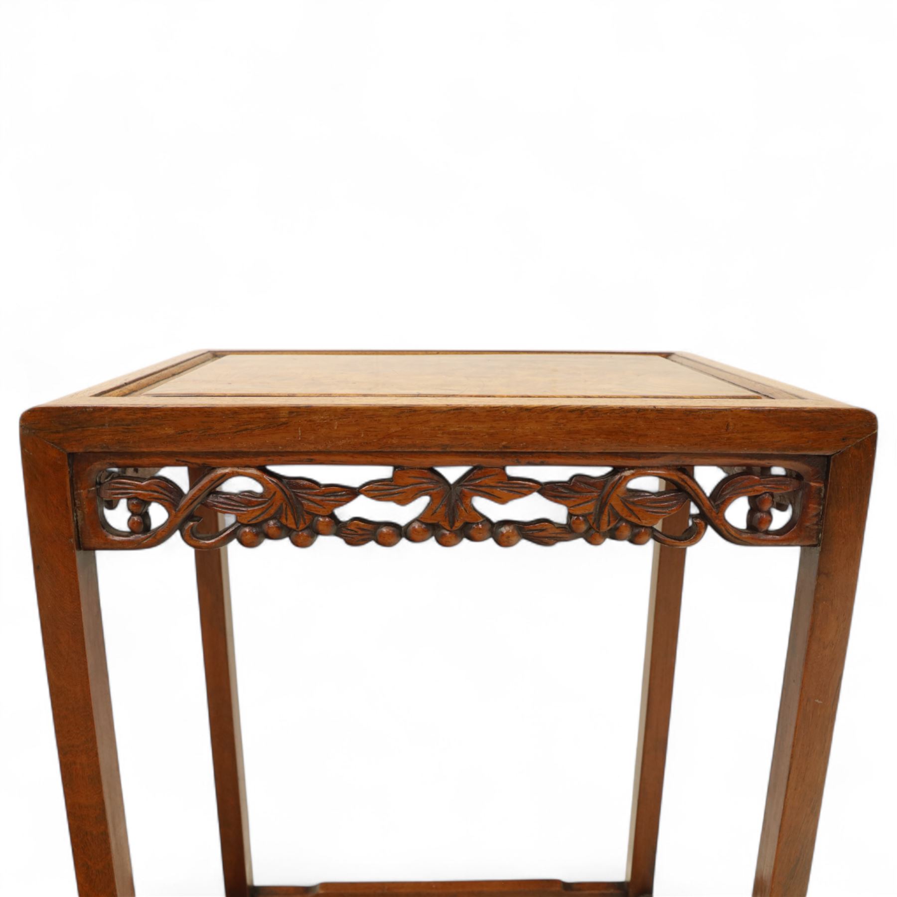 Early 20th century Chinese style hardwood quartetto nest of tables, each with panelled top and carved and pierced vine motif frieze, on square legs united by straight stretchers