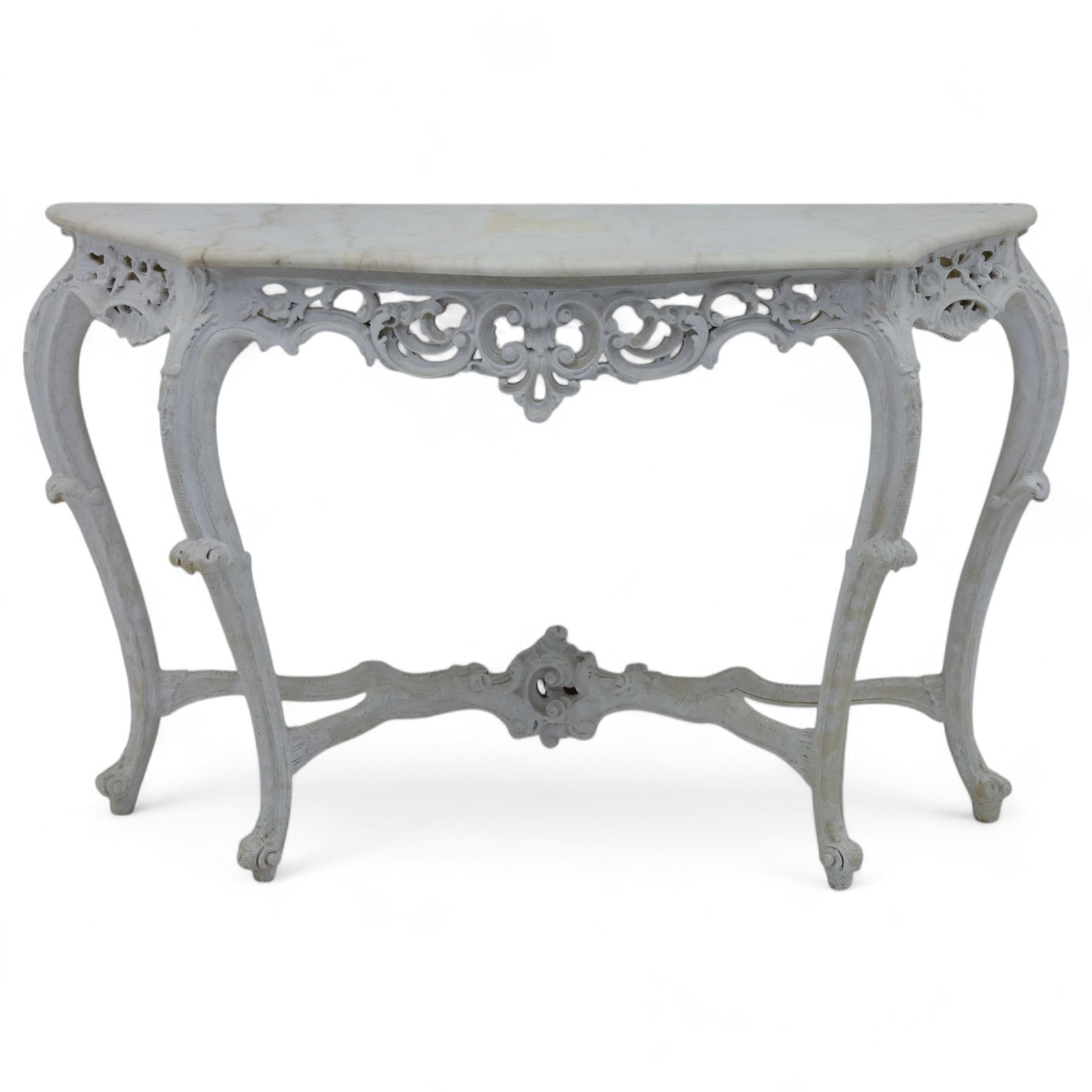 Early 20th-century Rococo revival-style console table, white serpentine-shaped marble top with moulded edge, frieze with openwork scrolling foliage, rocaille shells and deep apron, stretcher with central carved cartouche with shell and foliate motifs, supported on four cabriole legs, knees carved with acanthus leaf and terminating in scroll feet 