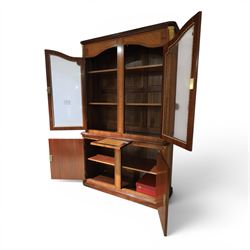 French style marquetry display bookcase, with twin glazed upper doors enclosing shelves, over a cupboard base inlaid with musical instruments and foliate decoration, the interior fitted with mirrored cupboard doors and a pull-out shelf, with gilt metal mounts and banding