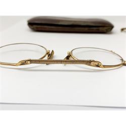 A pair of 9ct gold framed antique spectacles, marked 9 375, with case, together with a further pair, (testing around 9ct), and damaged pair (testing as gold plated). 