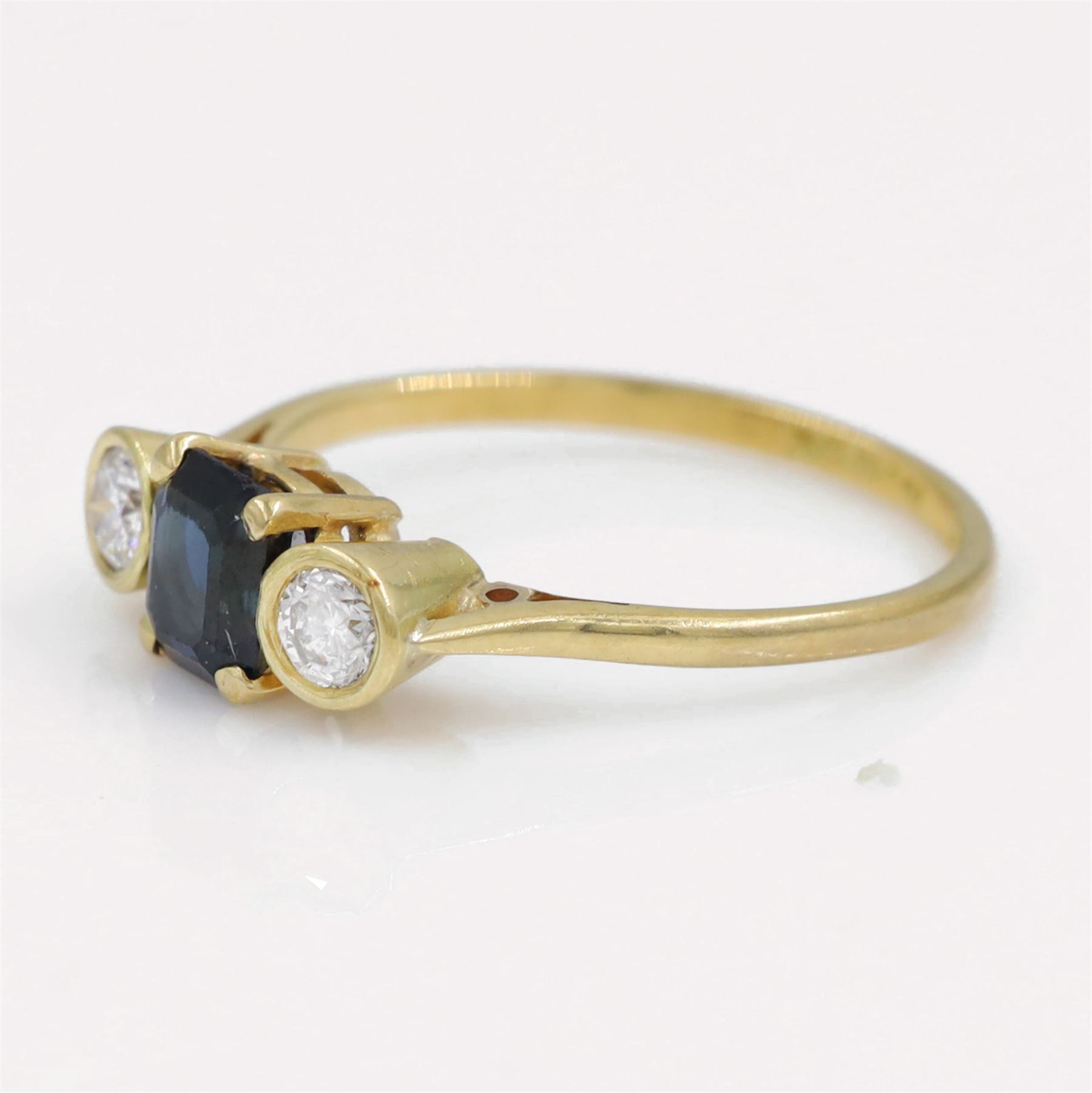18ct gold sapphire and diamond three stone ring, single octagonal cut sapphire, with a single round brilliant cut diamond set either side, total diamond weight approx 0.25 carat