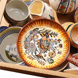 Collection of Quimper faience items including plates, cups, bowls and jug etc