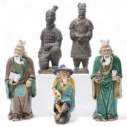 Three Chinese mud man figures, including man with fish, together with two terracotta warriors, H16cm