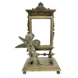 Late 19th/early 20th century brass rectangular toilet mirror, in the form of a Cherub holding an artist's pallet, on rectangular base with ball feet, H24cm