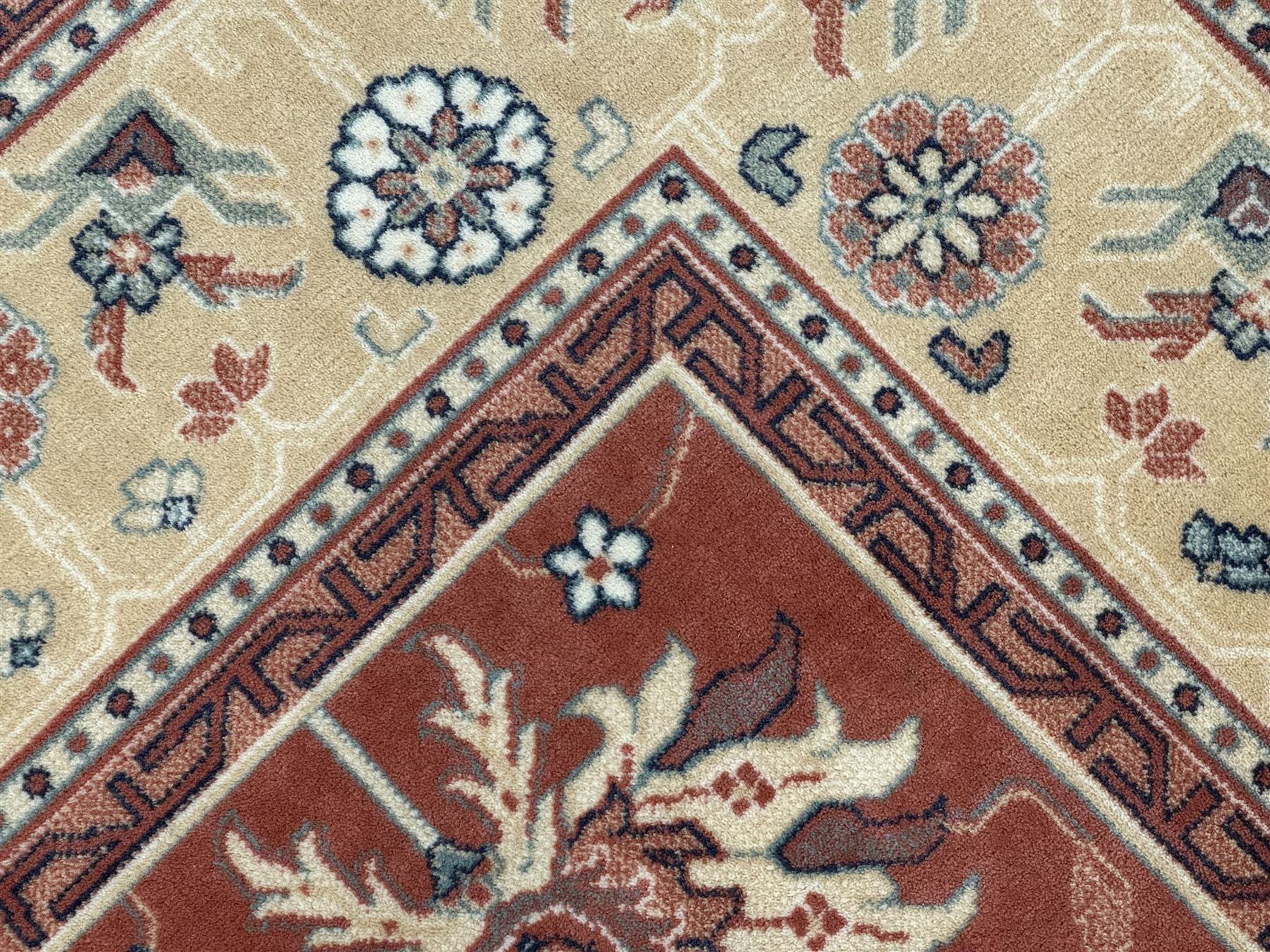 Late 20th century Royal Keshan 'Agra' hand-knotted wool rug, terracotta ground with central floral medallion and scrolling vines, enclosed by a cream border with repeating floral motifs