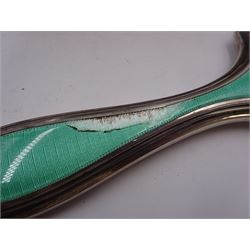 Art Deco five piece green guilloche enamel silver dressing table set, comprising hand mirror, two hair brushes and two clothes brushes hallmarked Barker Brothers Silver Ltd, Birmingham 1930, together with another silver brush, hallmarked Davis, Moss & Co, Birmingham 1928 (6)