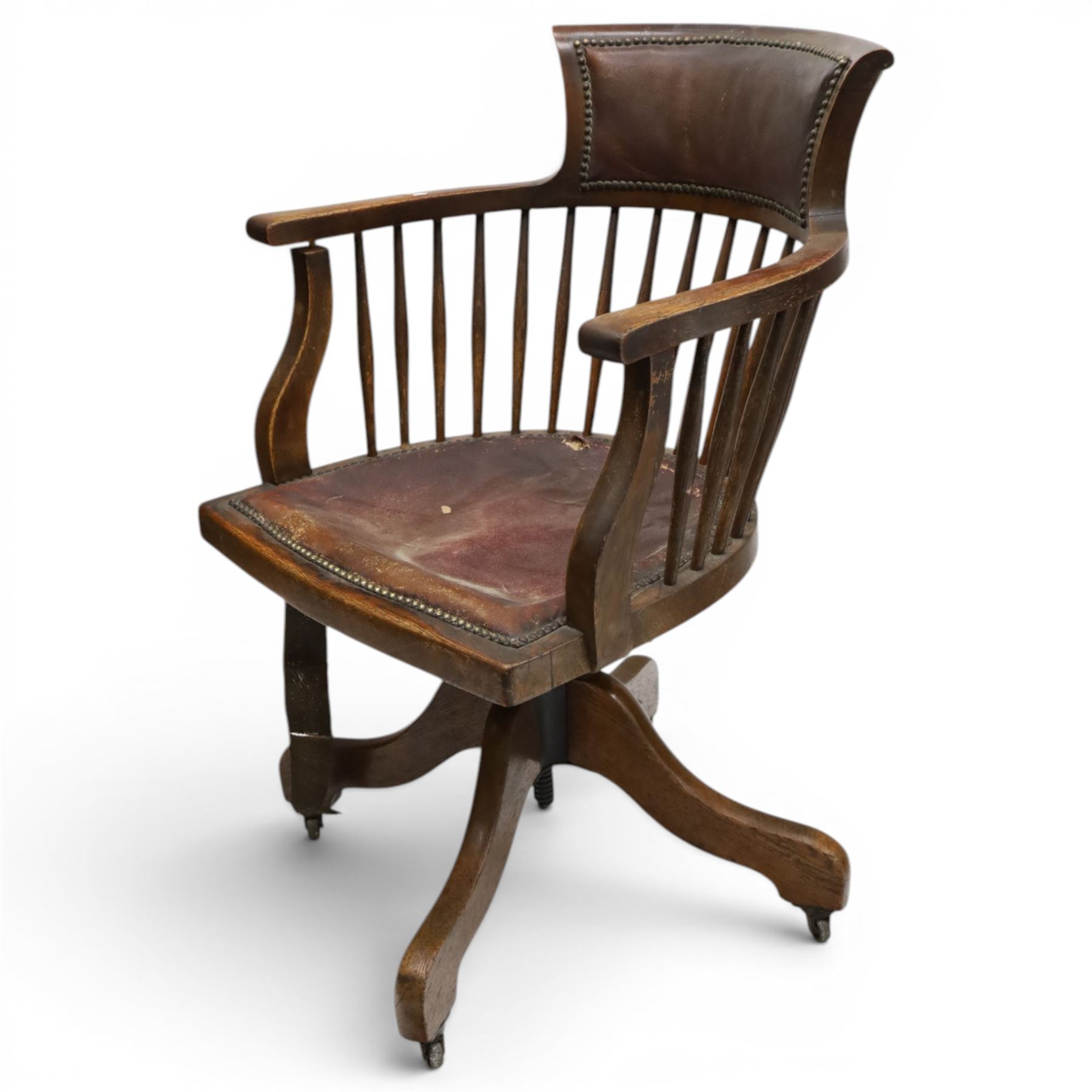 Late 19th century twin-pedestal desk, red leather inset top over an assortment of eleven drawers, on plinth base (W126cm D65cm H77cm); with Edwardian oak framed Captains swivel desk chair, of tub shaped form with spindle back supports (W60cm H89cm)