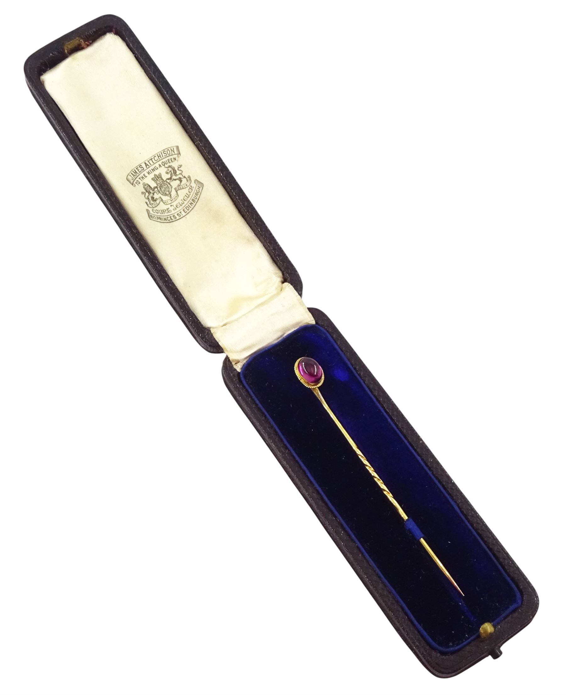 Two early 20th century gold stick pins, including a seed pearl set ribbon bow and cabochon garnet, one boxed