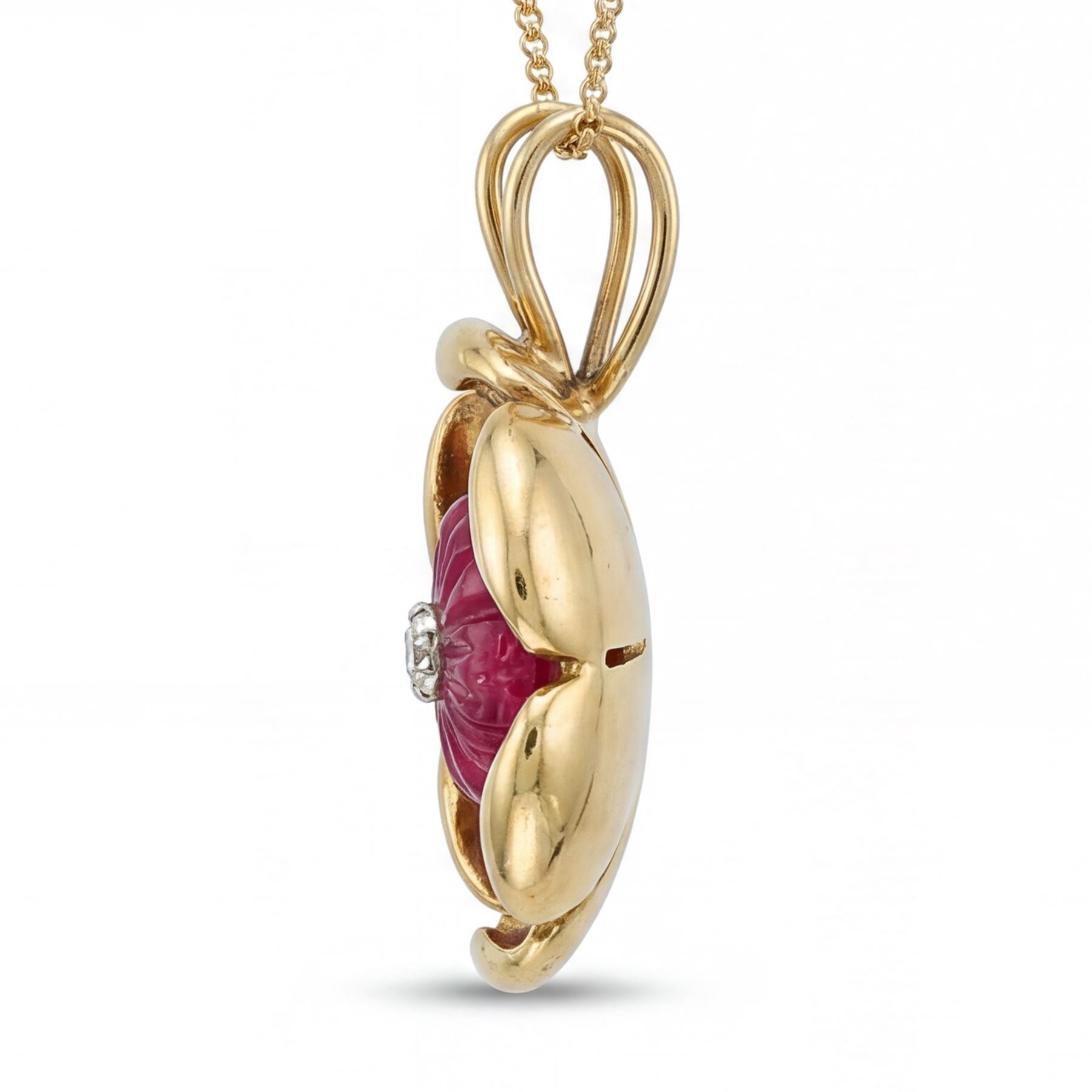 14ct gold ruby and diamond flower head pendant, carved ruby set with a single round brilliant cut diamond, on a 9ct gold trace link chain necklace
