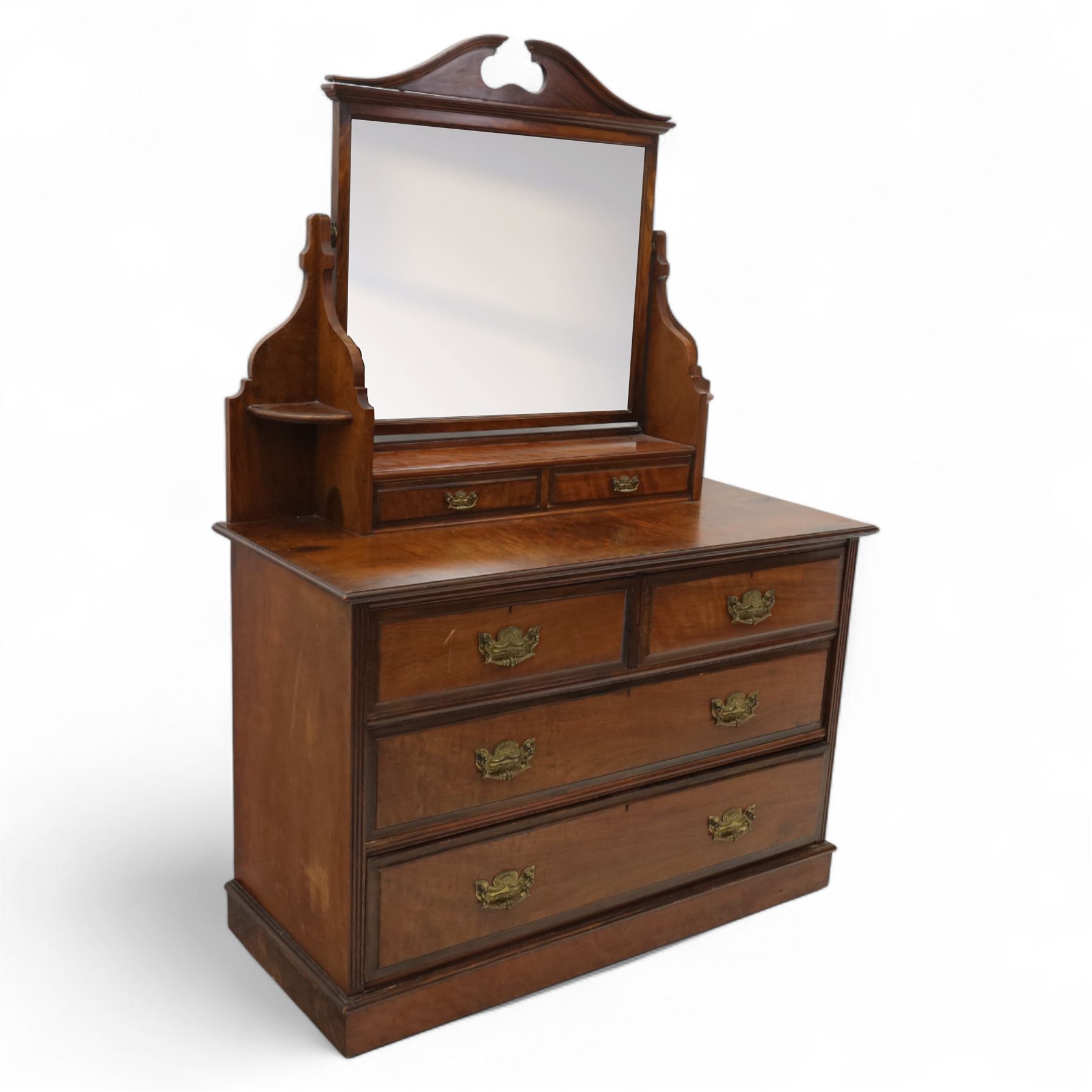 Edwardian walnut dressing chest, rectangular top surmounted by a mirror frame with shaped pediment on swing supports above two short frieze drawers over two short and three long graduated drawers fitted with brass foliate handles, raised on a plinth base