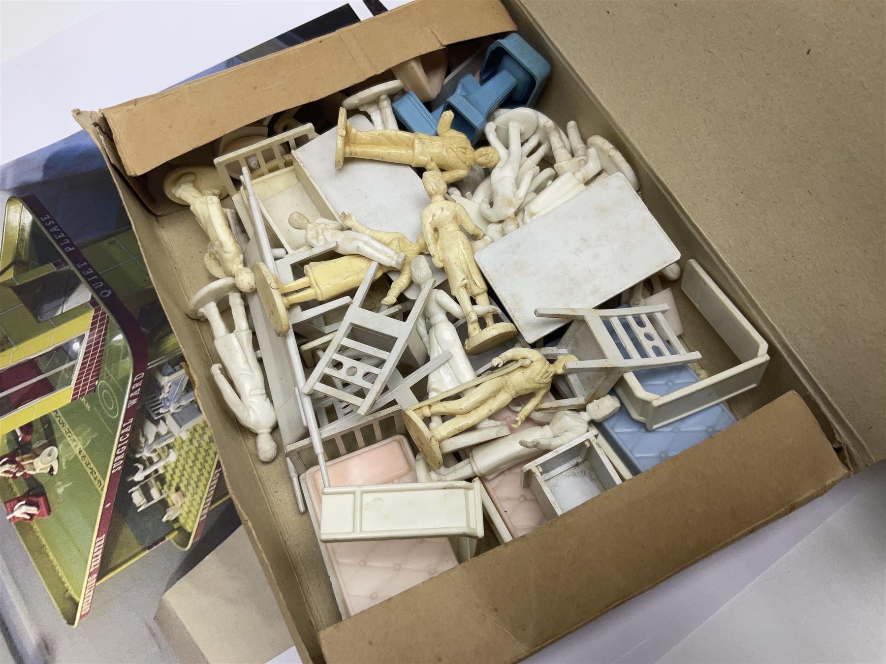 Late 1950s/early 1960s Mettoy tin-plate Emergency Ward 10 hospital set from the TV series, including over twenty figures, over sixty pieces of hospital equipment, beds, chairs, lockers, theatre fittings, stretchers etc; building is complete with movable transparent partitions, operating lift with sliding lift shaft doors and opening windows; wards with fitted swing doors; tin-plate walls with lithographed detail in yellow with red and white tiled effect, cobbled base with ambulance casualties area and lift access; boxed with instructions