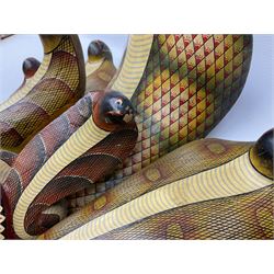 Sri Lankan Cobra mask depicting the demon Naga Raksha, together with a smaller example, largest H46cm