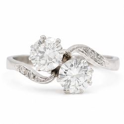 Platinum diamond crossover ring, set with two round brilliant cut diamonds and diamond set...