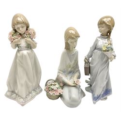 Three Lladro figures, comprising Flower Song no 7607, Spring Bouquets no 7603 and School Days no 7604, with original boxes, largest example H22cm 