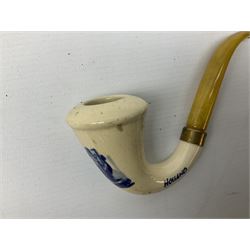Carved meerschaum and amber pipe with silver mount, the bowl carved as a woman, cased, clay pipe in the form of an acorn, ceramic pipe, five other pipes and a ceramic bottle pourer in the form of a horse  