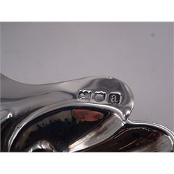 Victorian silver shell butter dish, upon three ball feet, hallmarked Josiah Williams & Co, London 1896, together with a 1920s silver egg cup, engraved 'Barbara', hallmarked Joseph Gloster Ltd, Birmingham 1929, a 1920s silver five bar toast rack, with loop handle, hallmarked William Greenwood & Sons, Birmingham 1928 and a mid 20th century silver milk jug, hallmarked James Dixon & Sons Ltd, Sheffield 1944, tallest H8.5cm