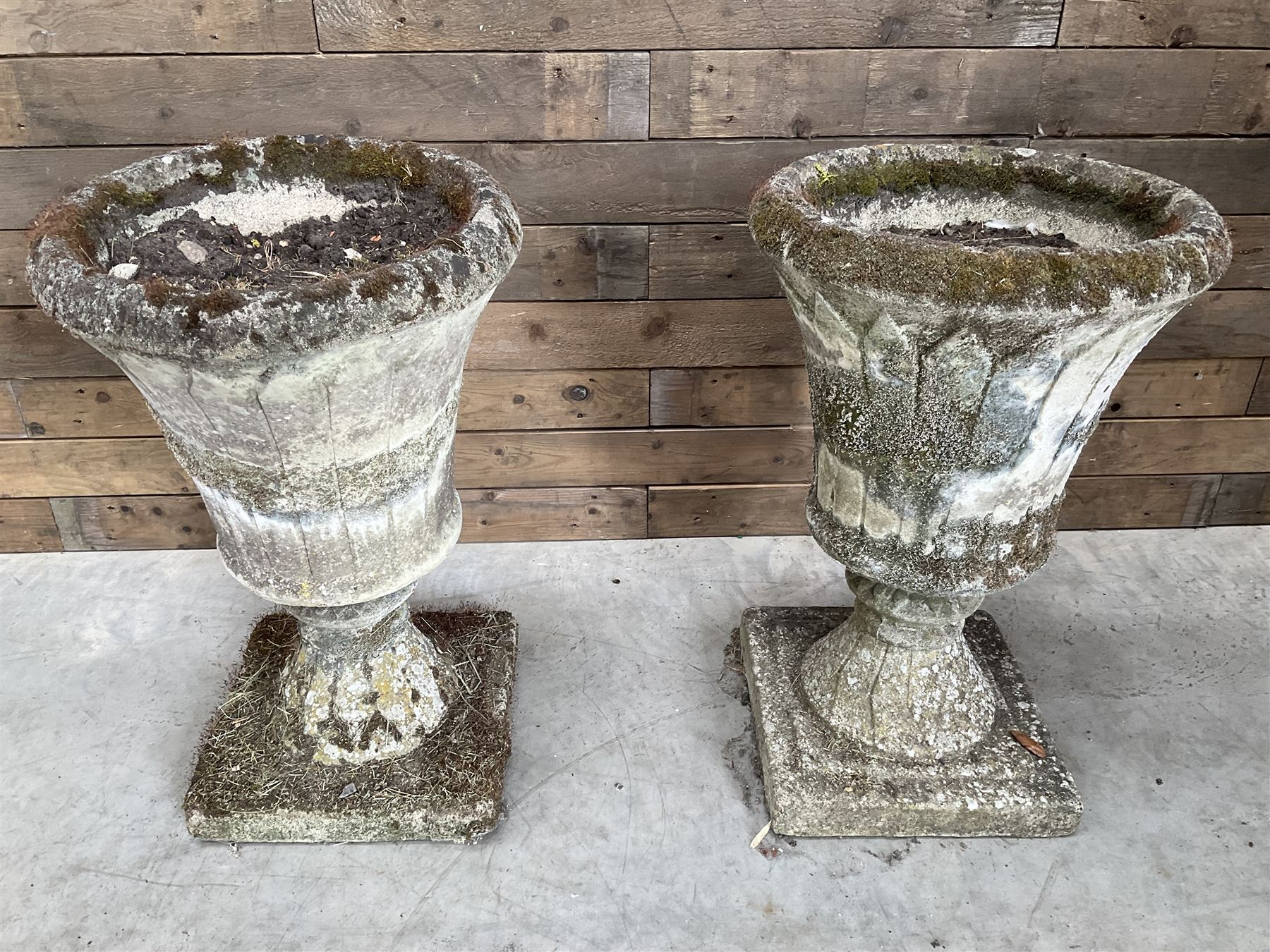 Pair of Regency design weathered cast stone garden urns