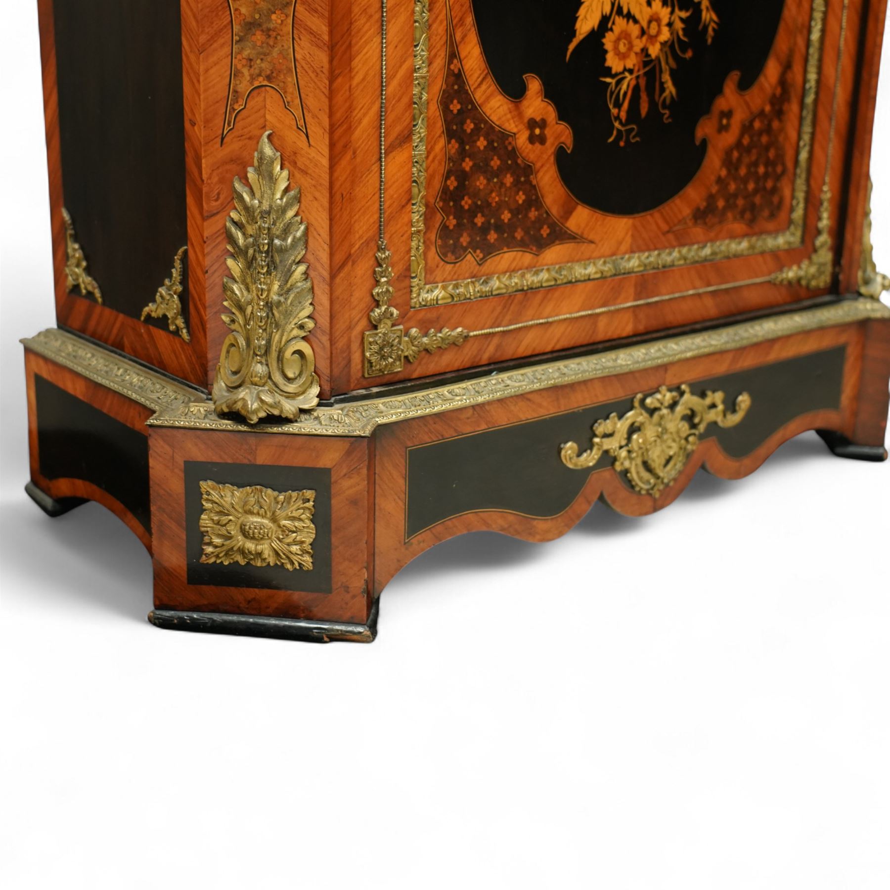 Late Victorian floral marquetry and ormolu mounted side cabinet, with white marble top above a frieze of floral inlay, single cupboard door revealing a shelved interior, with central floral bouquet panel within gilt-bronze border, flanked by gilt metal mounts of female masks and scrolls, on shaped plinth base