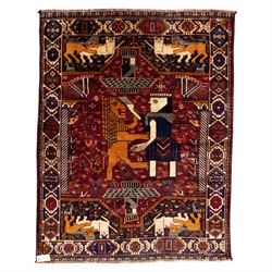 South West Persian Qahqai pictorial hand-knotted rug, madder red field with an all-over pa...