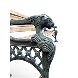 Neoclassical design cast iron and oak slatted garden bench, the twin end supports in the form of a Sphinx with acanthus carved knees and large paw feet, the pierced lattice bracket with Yorkshire rose motifs