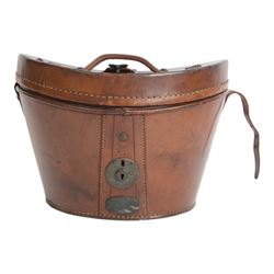 Bowler hat, by Moores, with retail label for Kendall of Scarborough, with brown leather top hat box having a handle to the lid and buckle fastening, lined in red velvet, marked W.B. to the front 