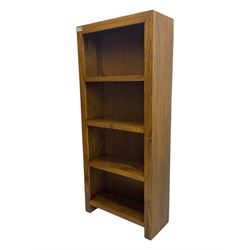 Contemporary Dakota mango wood open bookcase, rectangular form with four fixed open shelves, raised on stile supports