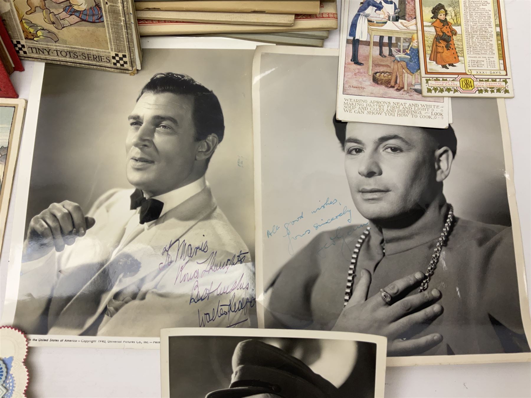 Early 20th century ephemera, to include signed photographs of Charles Boyer and Walter Pidgeon etc, a printed letter from Winston Churchill, two albums and a quantity of transfer books of Players and similar cigarette cards, including Boy Scout and Girl Guide Patrol Signs and Emblems and RAF Badges, a collection of greetings cards and postcards, a photograph album containing black and white photographs of Caius College Cambridge and guides and pamphlets on travelling Switzerland and the UK