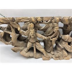 Two carved oriental wall hangings, the first example gilded depicting a temple and garden scene, the second figures in a garden, L49cm