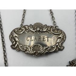 Five modern silver decanter labels, to include two sherry examples, embossed with scrolls and fruits, hallmarked W I Broadway & Co, Birmingham 1991 & 1997, a similar claret example, hallmarked S J Rose & Son, Birmingham 1973, and two plain shaped port and burgundy examples, hallmarked C Robathan & Son, Birmingham 1997 and A Haviland-Nye, London 1968