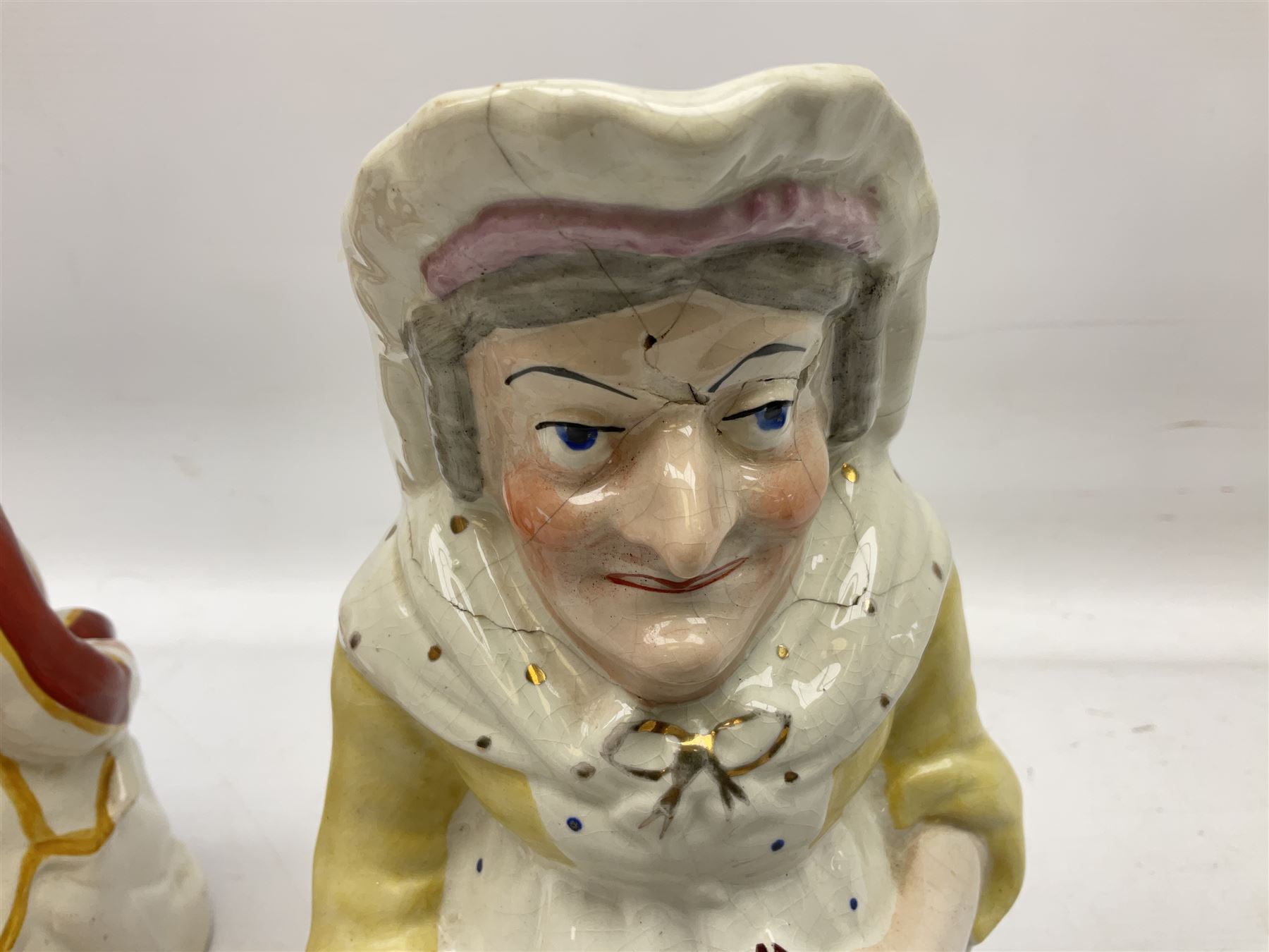 19th century and later Toby jugs comprising Staffordshire Punch and Judy jugs, Victorian 'I am on the black list' jug, two jugs in the form of Toby with a jug of beer (5)
