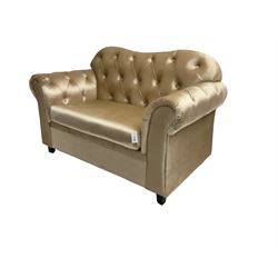 Chesterfield shaped snuggler sofa, upholstered in buttoned champagne fabric, with scatter cushions