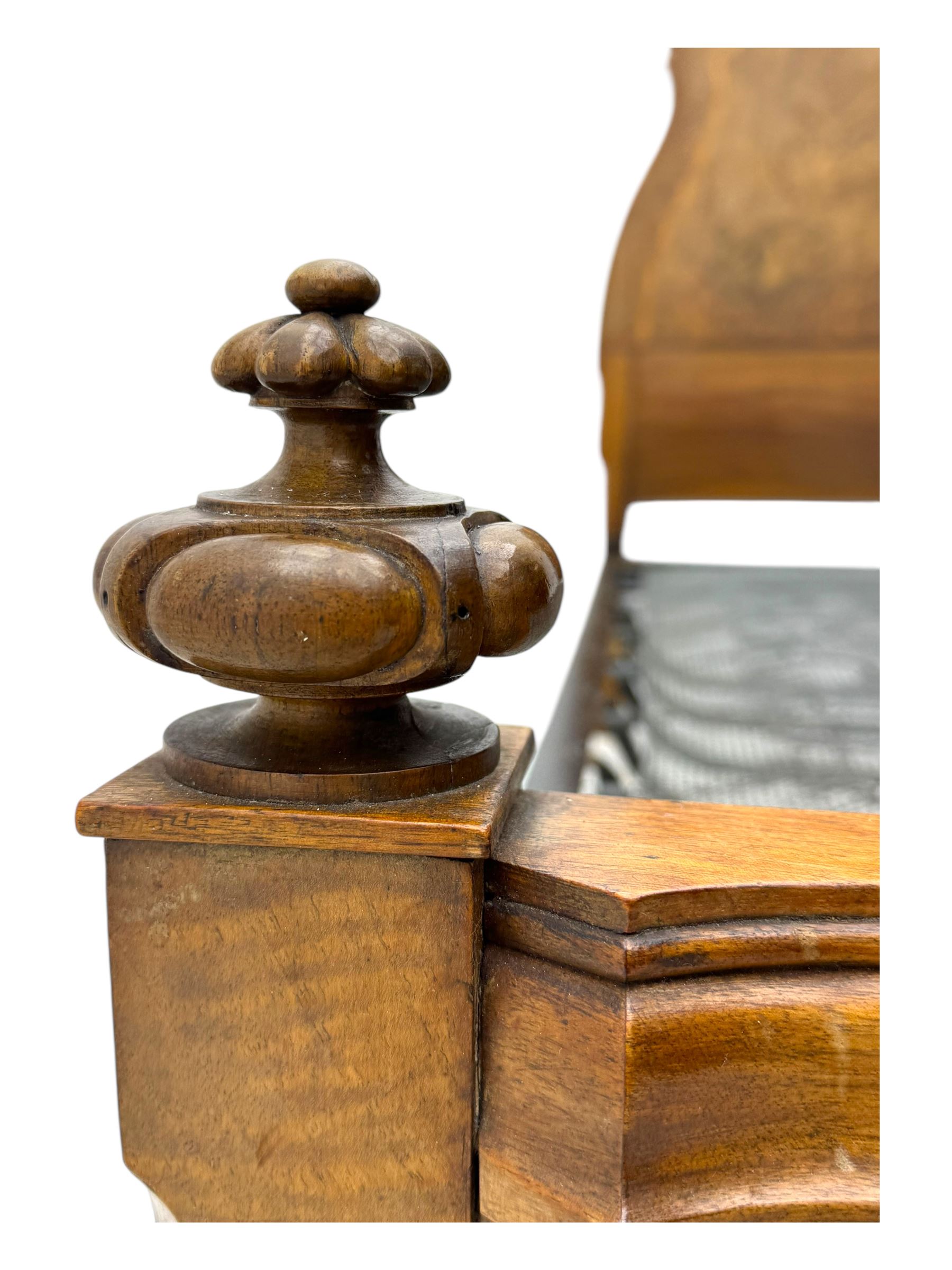 Mid-20th century walnut single bedstead, high shaped headboard, footboard with turned finials and scrollwork carvings, complete with 'Vono' iron frame, raised on cabriole supports