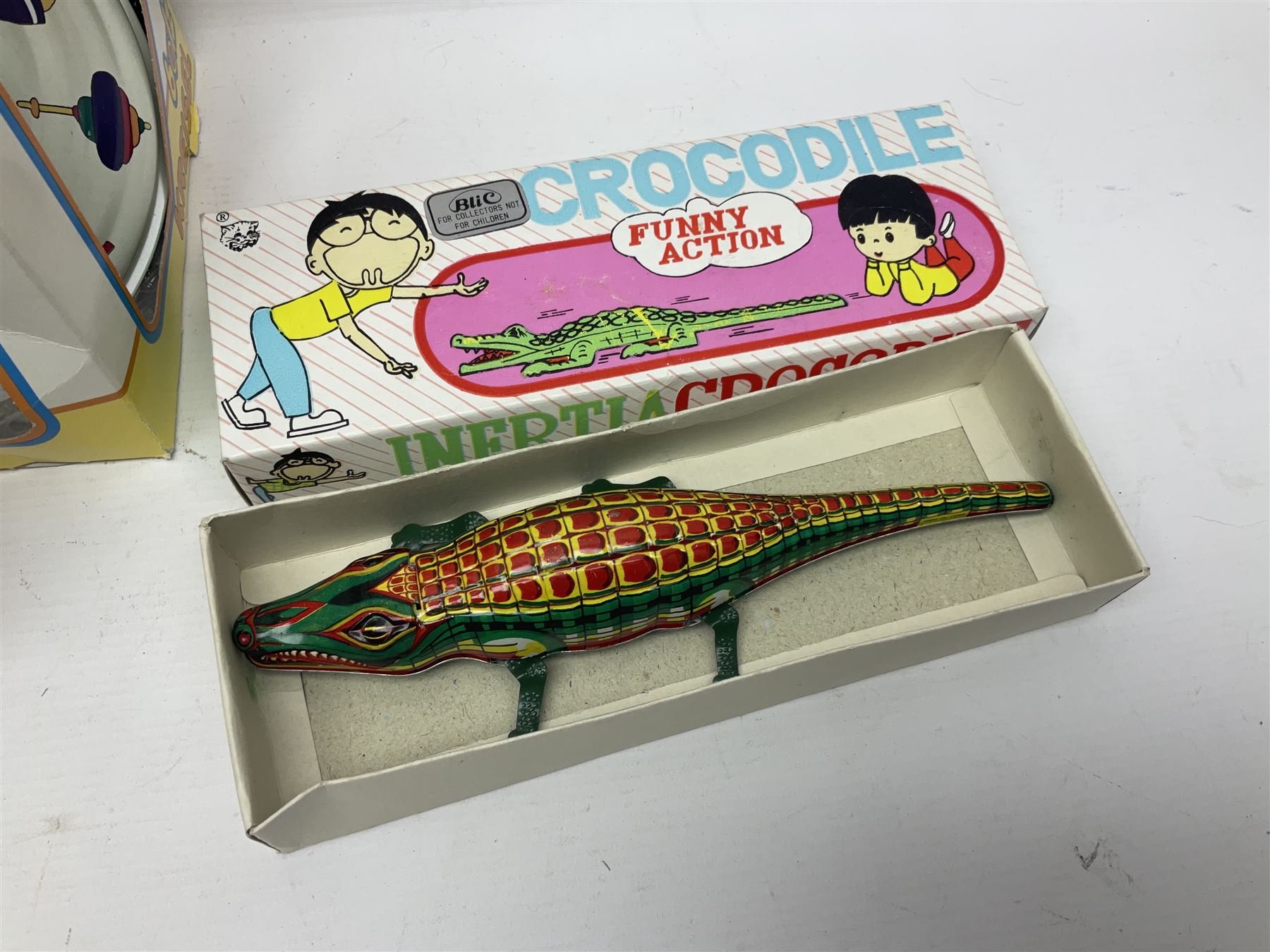 Twenty six tinplate models to include Ferris Wheel and Performing Circus Elephant, marked JW, further similar examples such as Duck on a Bike, Clown on Roller, Carousel; Popeye Tin Speedboat; Looney Tunes Wind Up Cars and Express Train; various international examples, MS107 Jumping Bambi, Pop Pop Boat, jumping frogs, pecking chickens etc; both boxed and loose
