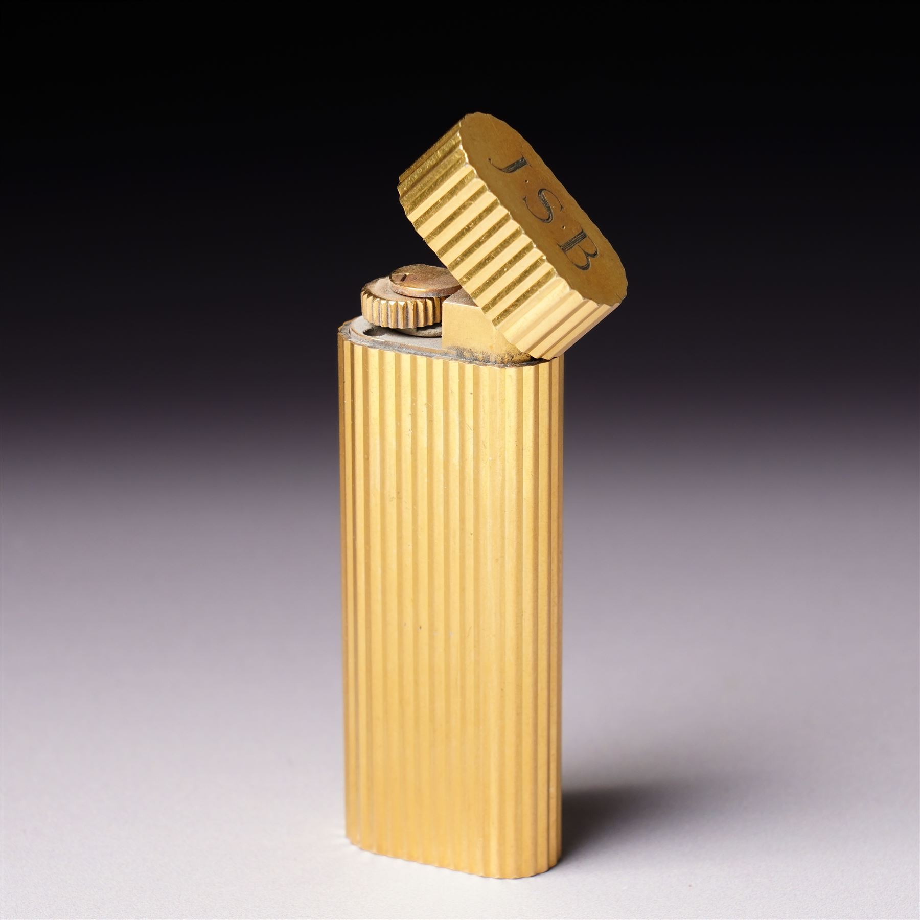 Vintage Cartier gold plated lighter with rounded edges and textured finish marked 'Cartier, Paris No16061A' and inscribed with initials in original Cartier case 
