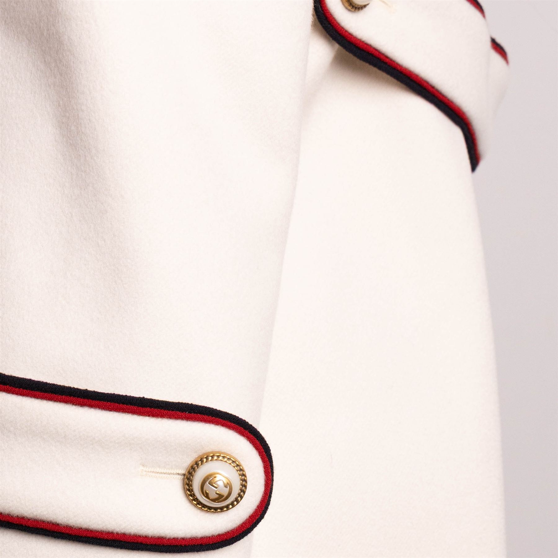Gucci - bee embroidered wool single-breasted military coat, from the Autumn/Winter 2017 collection under Alessandro Michele, in ivory, with stand collar, red and navy trim, pearlescent and gold-tone button fastening and embroidered bee detailing to the collar, size 14, unused with original garment bag and tags