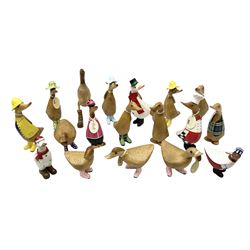 Quantity of the Duck Company UK DCUK carved bamboo root ducks, modelled wearing rain hats and rain boots etc, together with other similar carved wood ducks, tallest H26cm